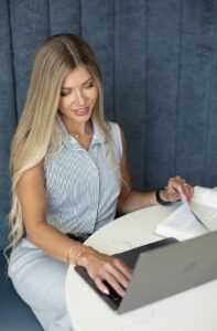 Strength and fitness coach Natalie Suazo creating a workout program for a powerlifting athlete.